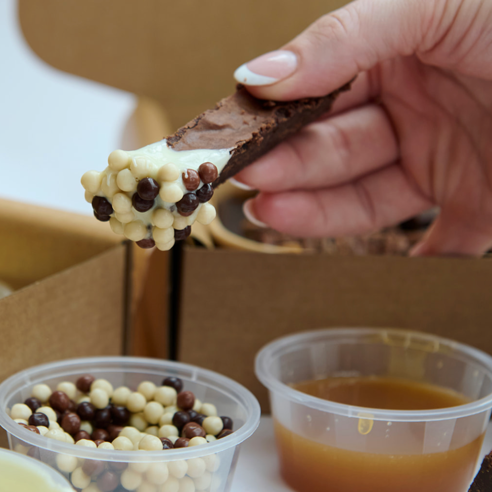 The Brownie Box UK Postal Ultimate Brownie and Blondie Dipping Box Posted Nationwide. Contains Brownies, Blondies, Dipping Sauces &amp; Chocolate Crumb.