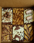 The Brownie Box UK Postal Brownies, Delivered nationwide. Blondie Brownie Box. Malteser Brownie, double decker brownie, milka brownie, biscoff blondie, nutella blondie, mars bar blondie Box of 6